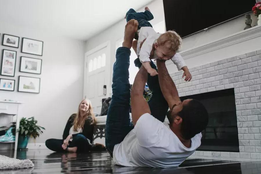 Romulo Melo playing with his son.